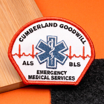 Cumberland Goodwill Emergency Medical Services embroidered patch featuring a blue Star of Life and EKG line motif.