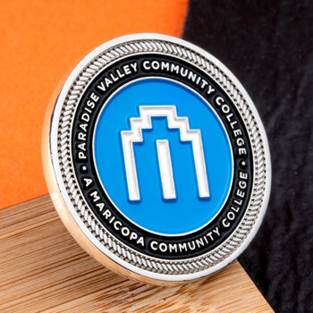 Paradise Valley Community College challenge coin with blue enamel and silver rope edge.