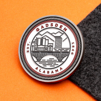 Circular Gadsden Alabama challenge coin featuring a city bridge and waterfall design on a white background with a textured border.